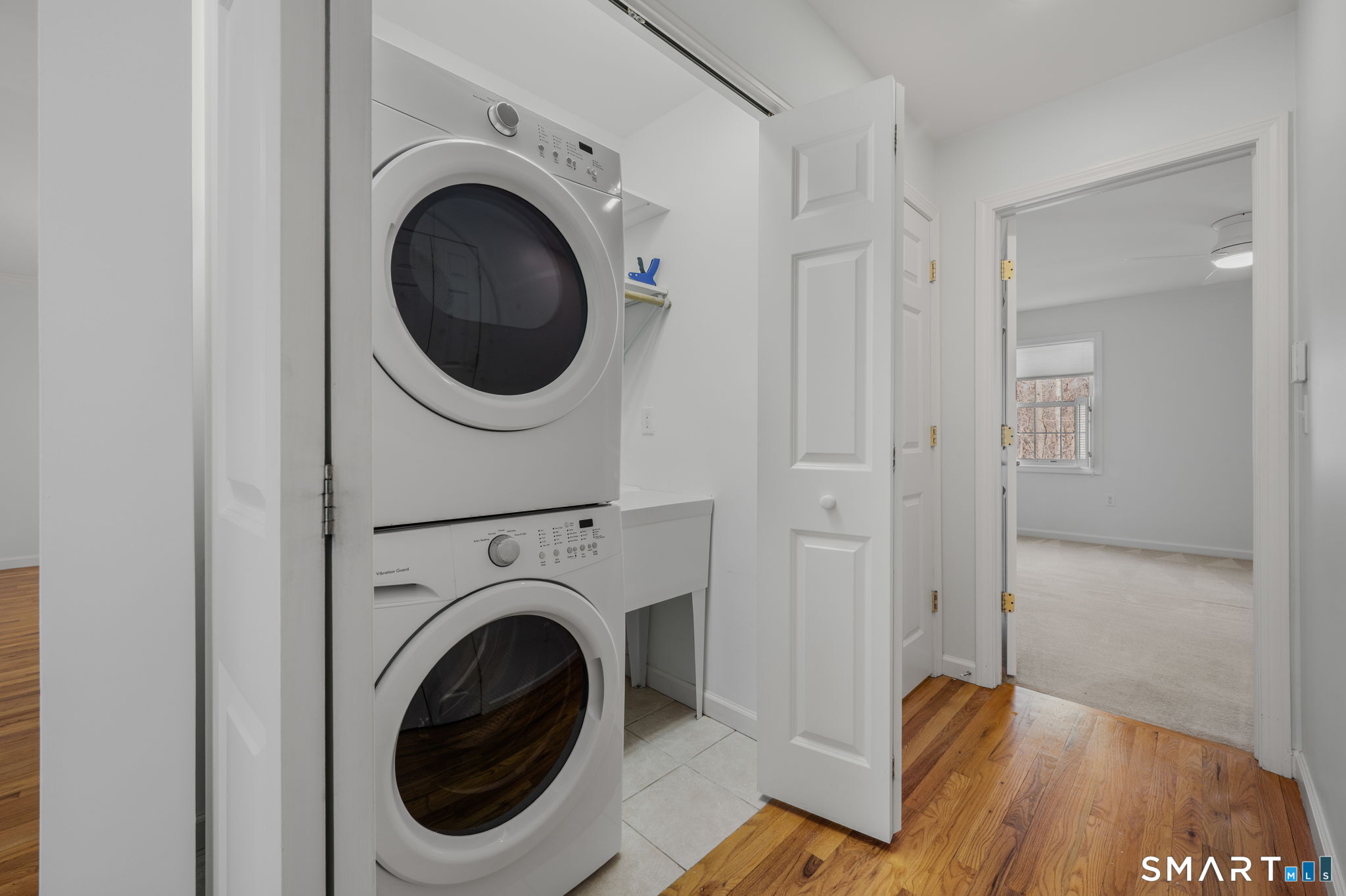 1 Bittersweet Lane, Unit 1 East Lyme, CT 06357 - Photo 15 of 26 a view of a hallway with washer and dryer