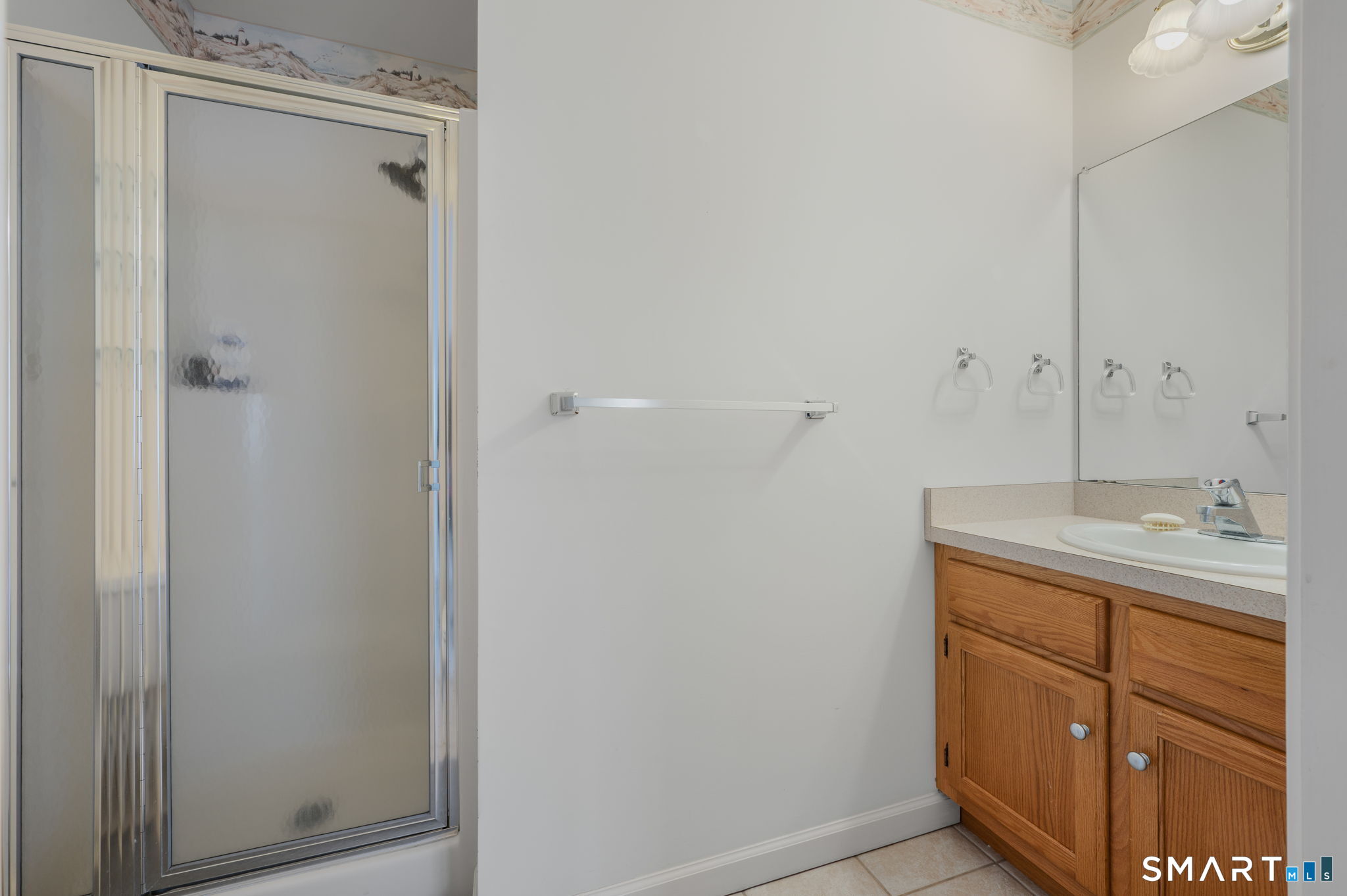 1 Bittersweet Lane, Unit 1 East Lyme, CT 06357 - Photo 19 of 26 a bathroom with a sink a vanity and a mirror