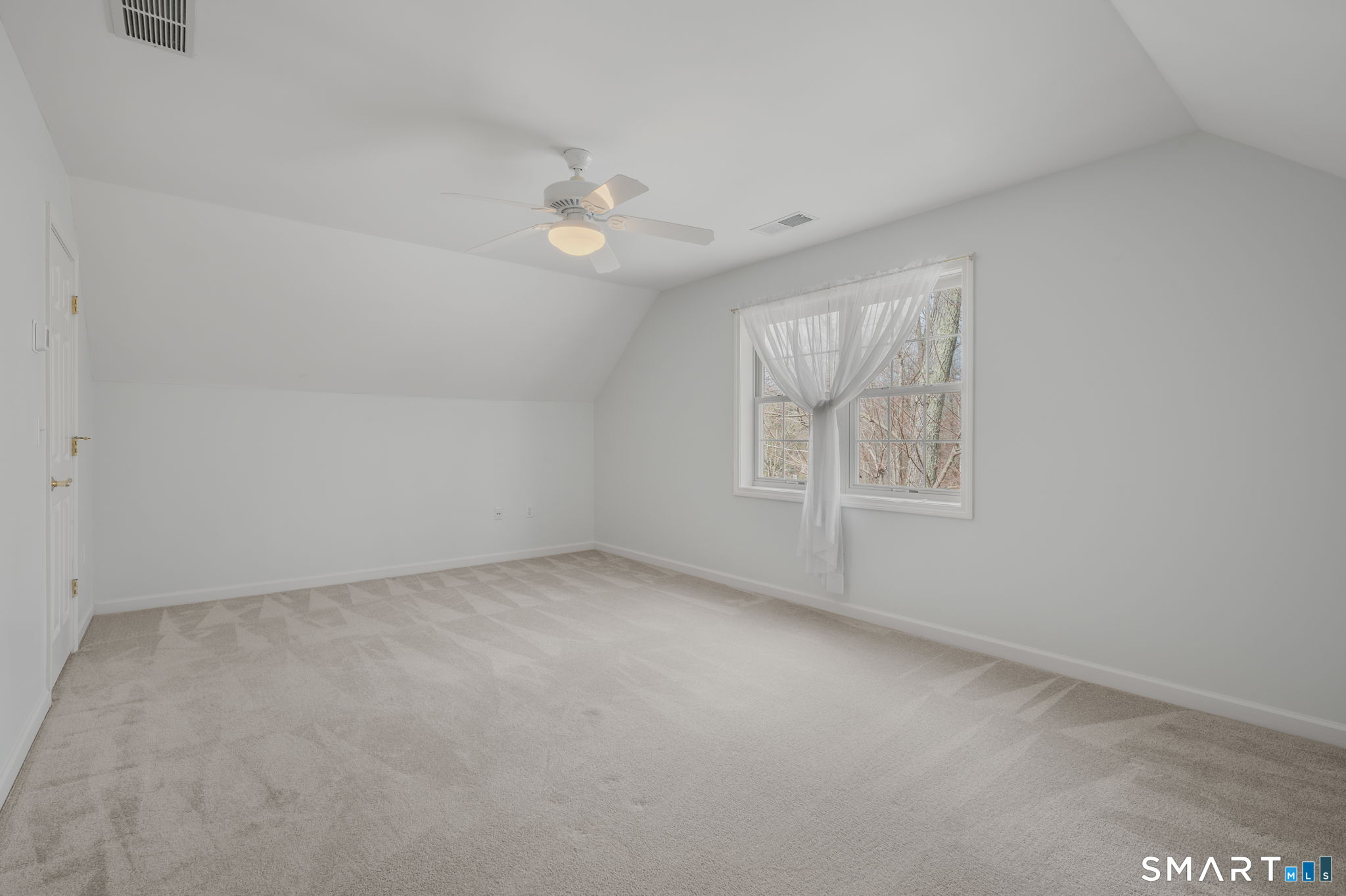 1 Bittersweet Lane, Unit 1 East Lyme, CT 06357 - Photo 23 of 26 an empty room with windows and fan