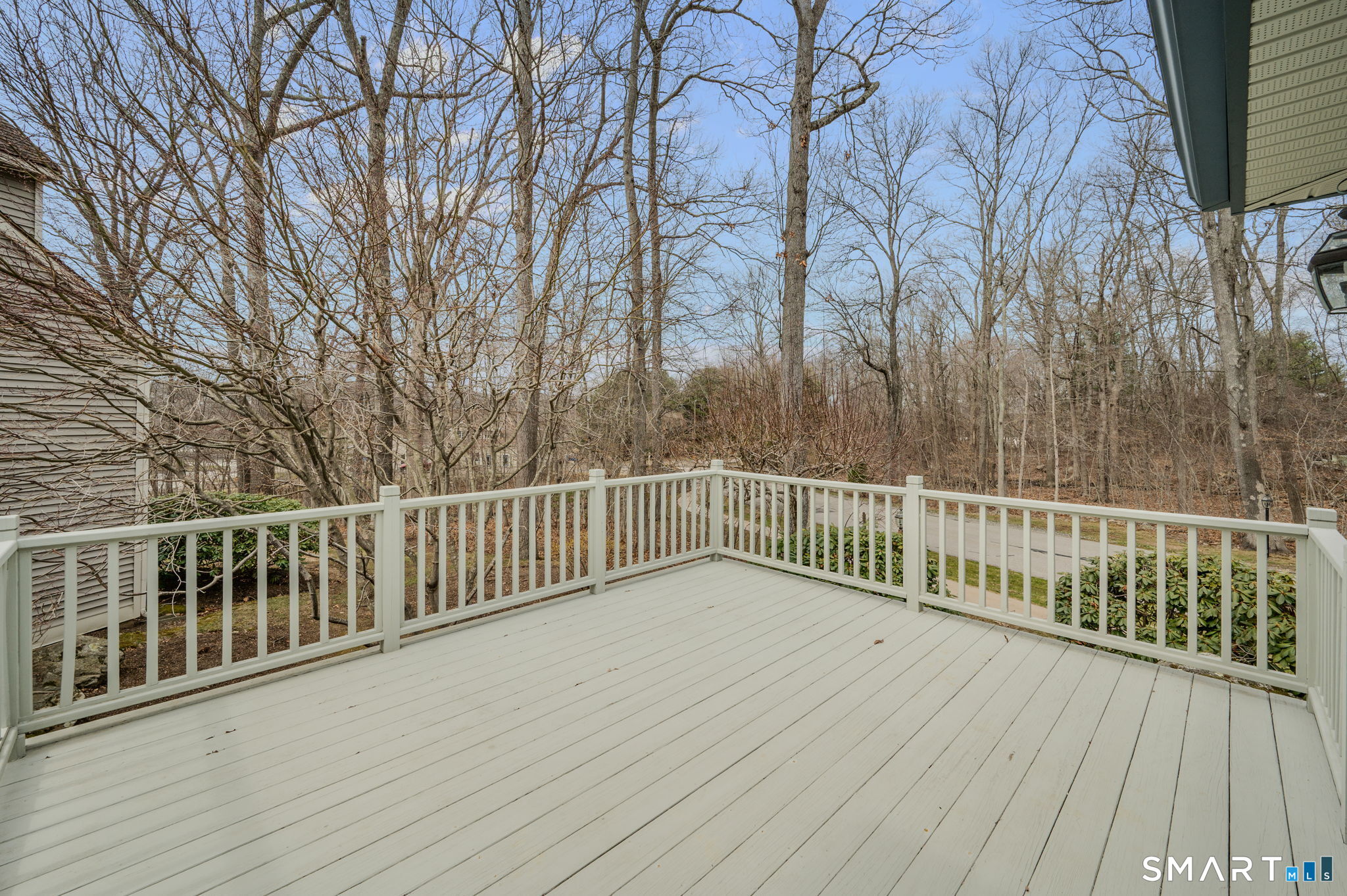 1 Bittersweet Lane, Unit 1 East Lyme, CT 06357 - Photo 4 of 26 a view of a balcony with wooden floor and fence