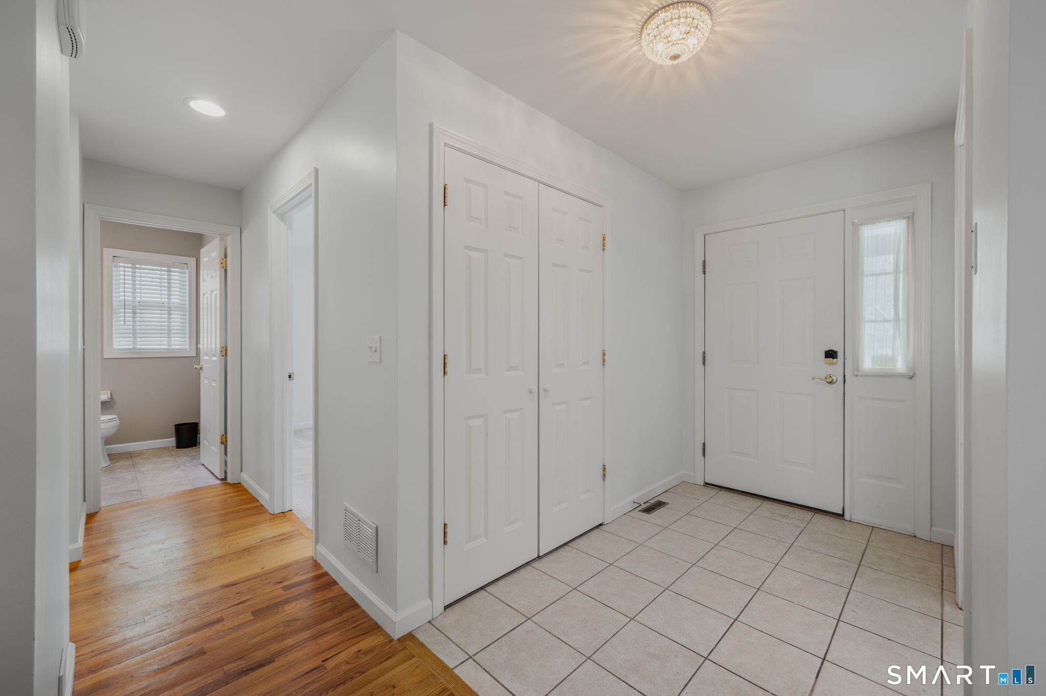1 Bittersweet Lane, Unit 1 East Lyme, CT 06357 - Photo 6 of 26 a view of a livingroom with an empty space and a hallway