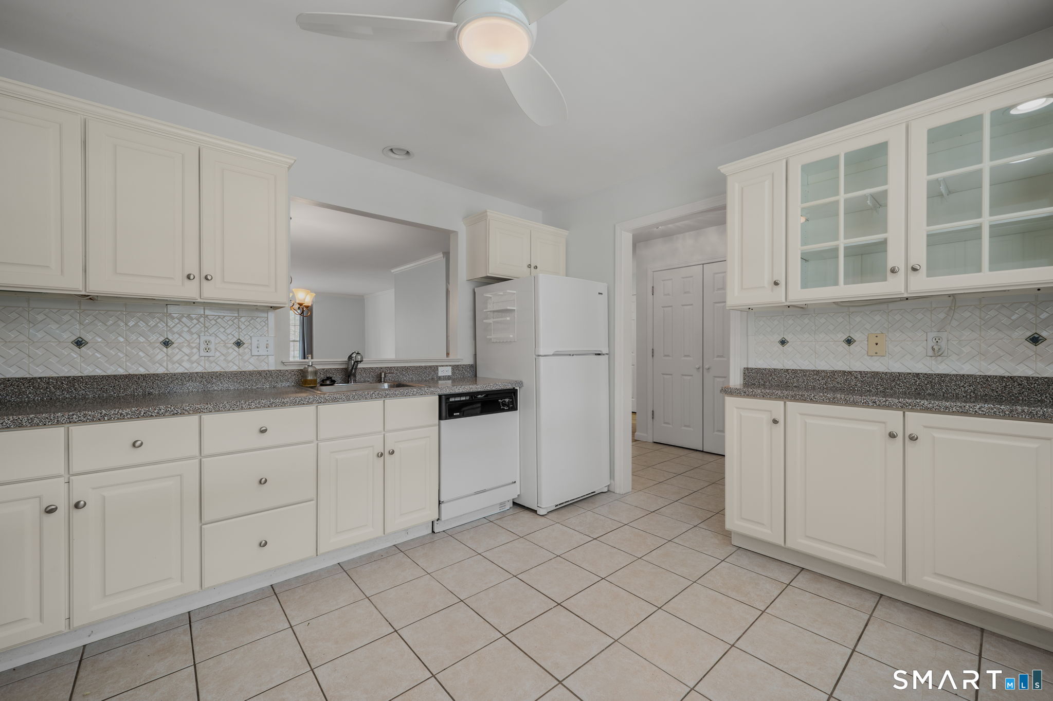 1 Bittersweet Lane, Unit 1 East Lyme, CT 06357 - Photo 9 of 26 a kitchen with white cabinets granite counter tops and white appliances
