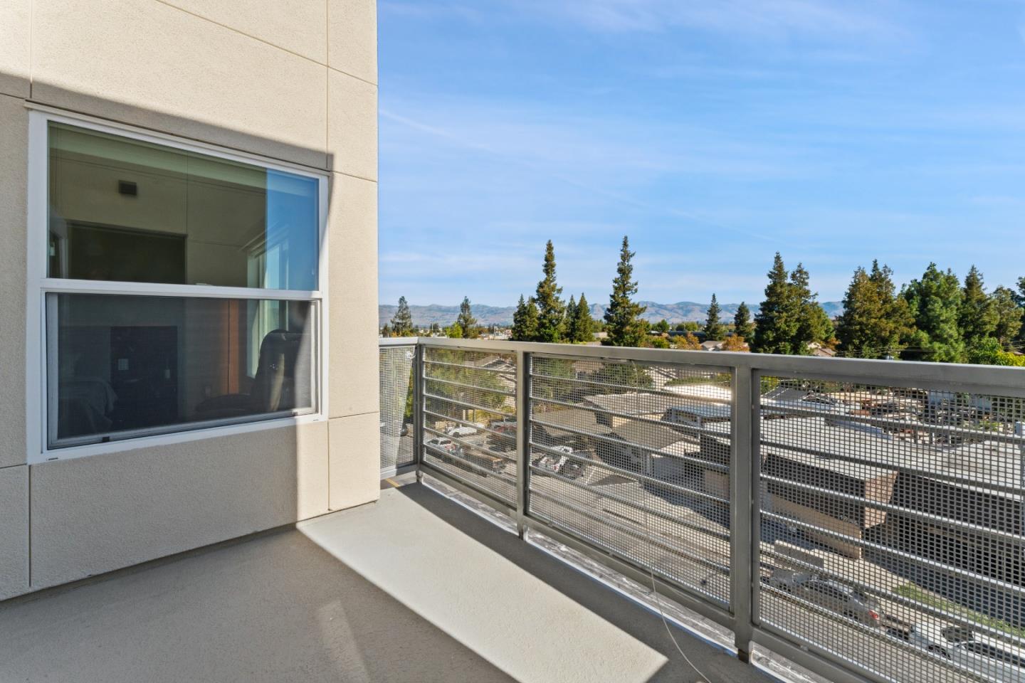 1853 Almaden Road, Unit 504 San Jose, CA 95125 - Photo 10 of 18 a view of a balcony with a floor to ceiling window and wooden fence