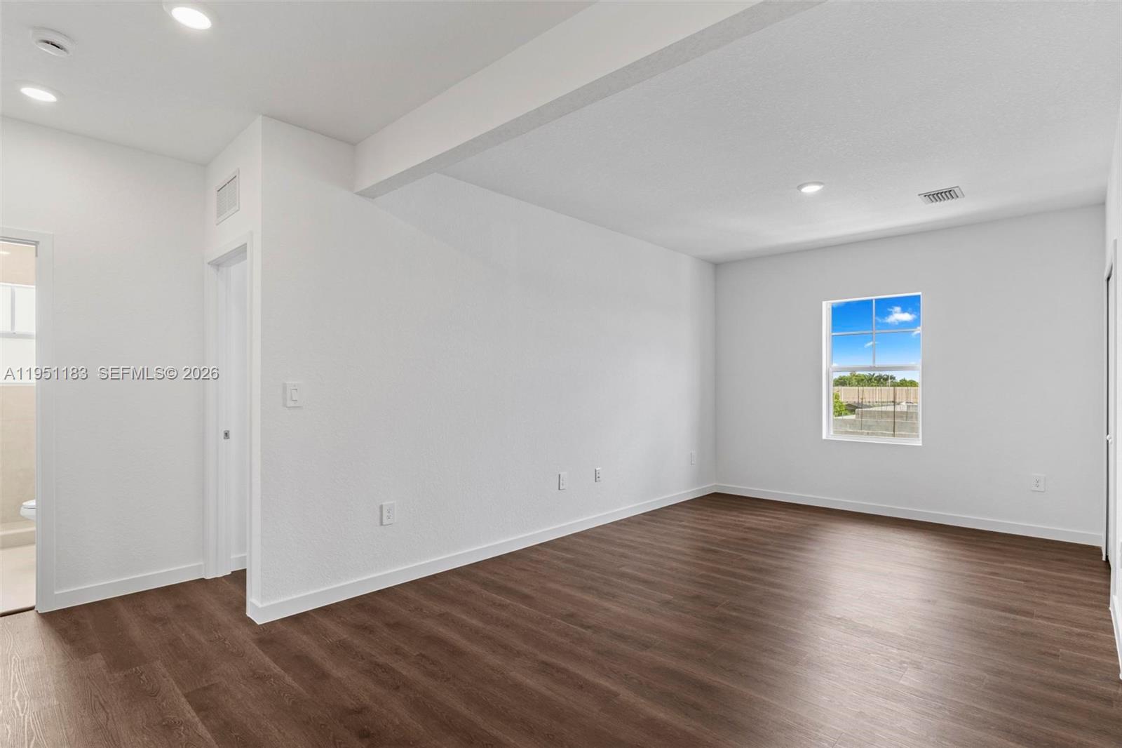 13361 Southwest 272nd Lane Homestead, FL 33032 - Photo 17 of 27 an empty room with wooden floor and windows