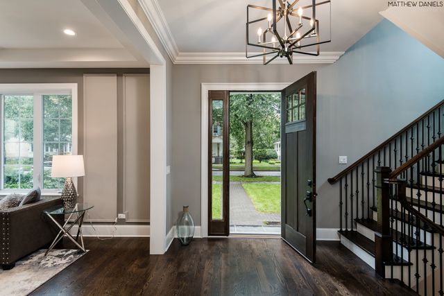 a view of a room with wooden floor staircase and windows