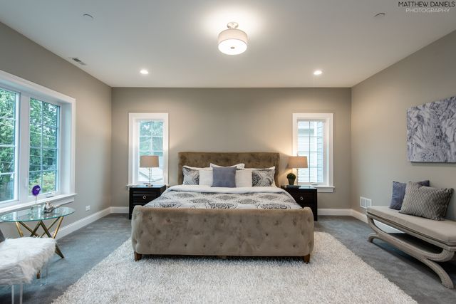 a bedroom with a bed and a couch