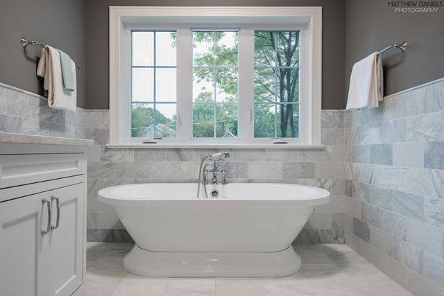 a white bath tub sitting in a bathroom