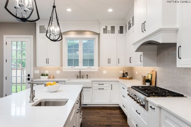 a kitchen with a stove a sink and a refrigerator