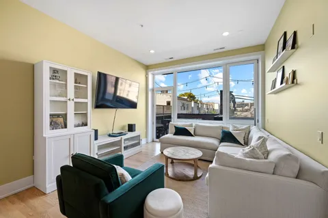 a living room with furniture and a large window
