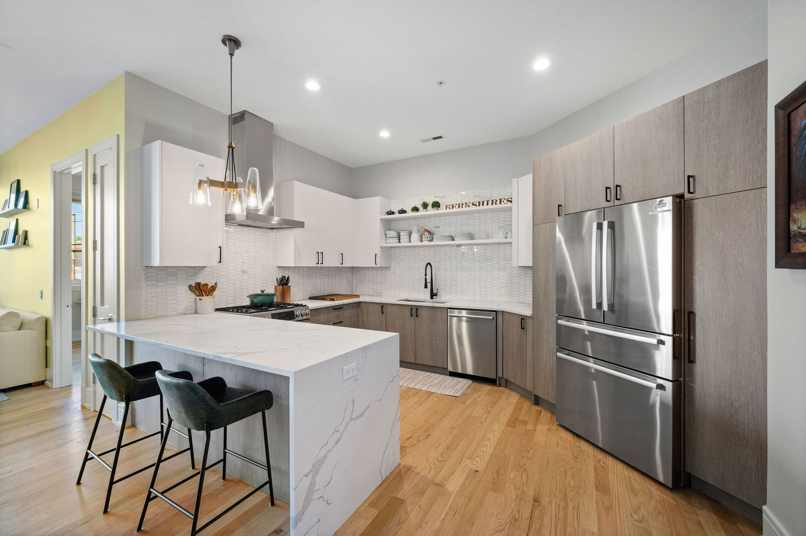 3101 North Ridgeway Avenue, Unit 2E Chicago, IL 60618 - Photo 5 of 18 a large kitchen with a center island wooden floor stainless steel appliances and cabinets