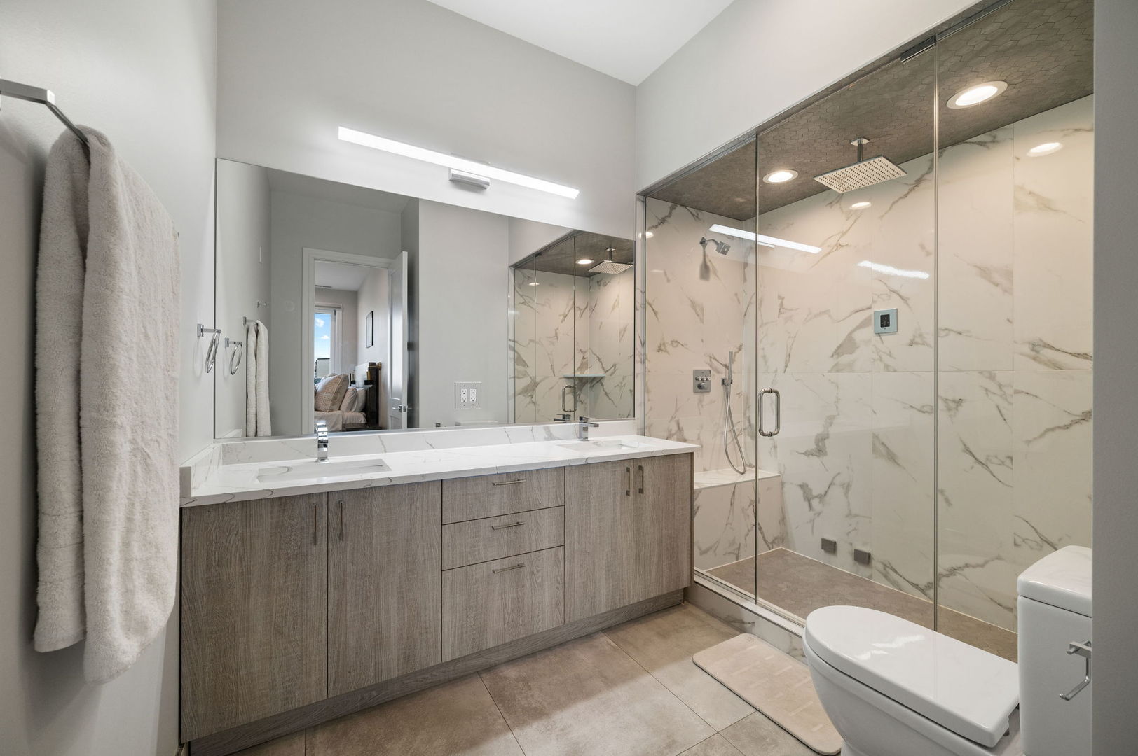 3101 North Ridgeway Avenue, Unit 2E Chicago, IL 60618 - Photo 8 of 18 a bathroom with a double vanity sink toilet and shower
