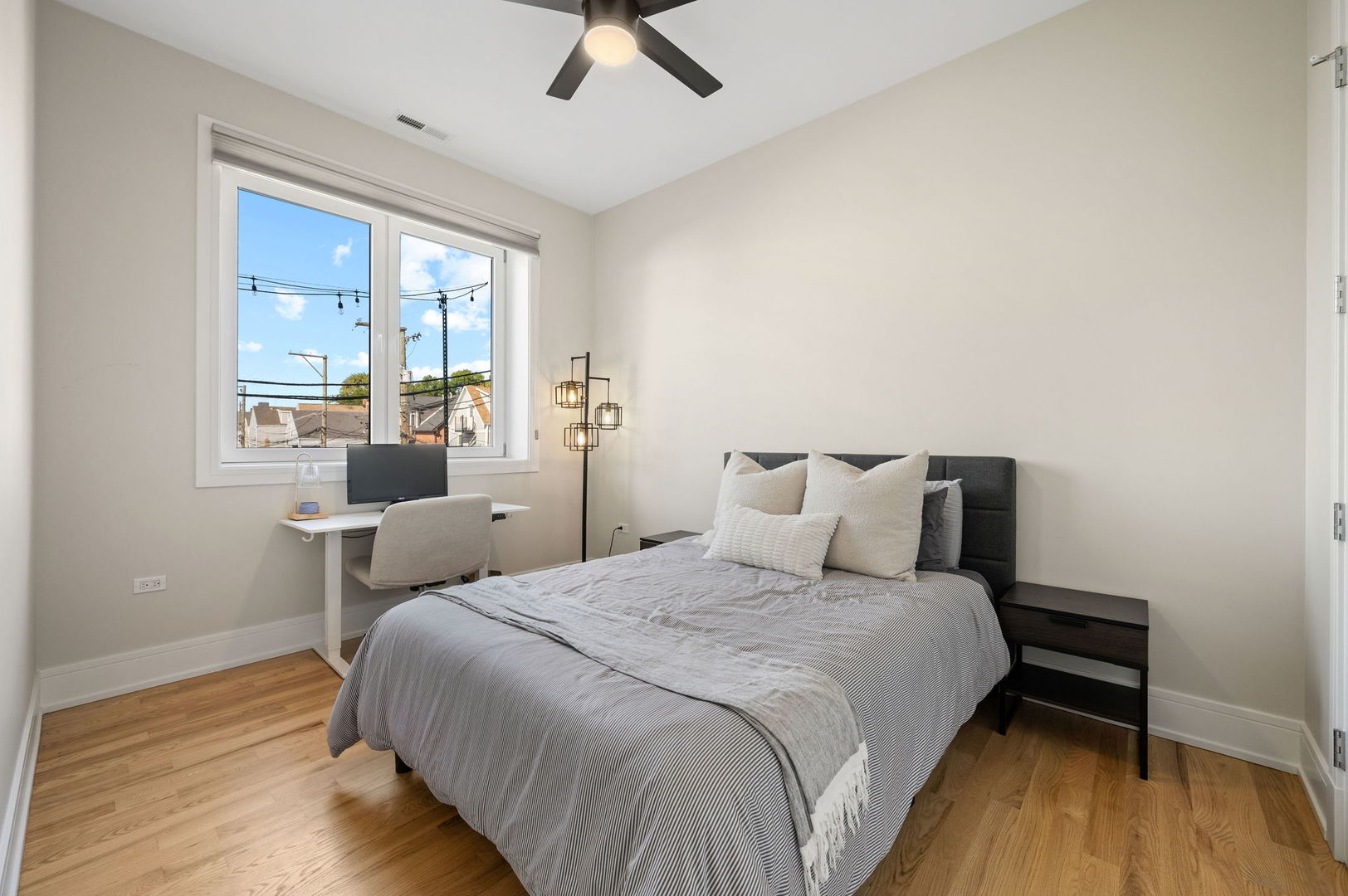 3101 North Ridgeway Avenue, Unit 2E Chicago, IL 60618 - Photo 9 of 18 a bedroom with a bed a chandelier and a window