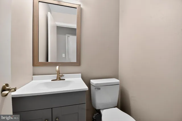 a bathroom with a sink toilet and mirror