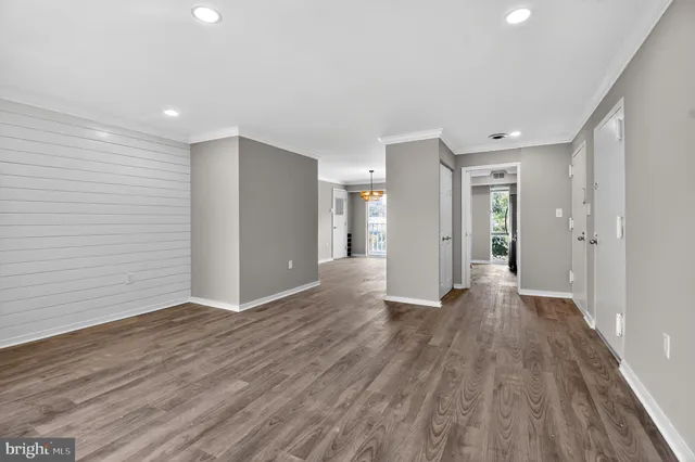 a view of an empty room with wooden floor