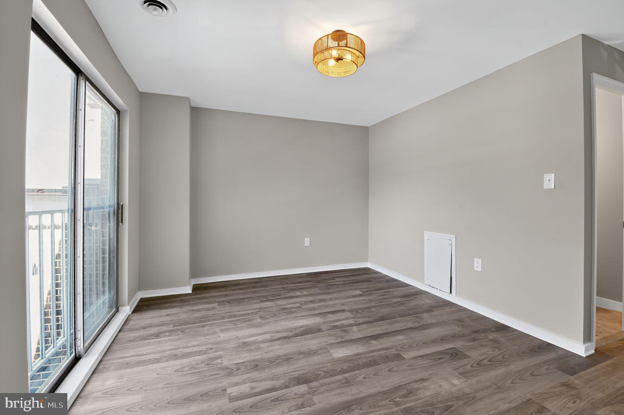 3234 Hewitt Avenue, Unit 34B Silver Spring, MD 20906 - Photo 10 of 17 wooden floor in an empty room with a window