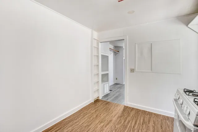 a view of closet area with wooden floor