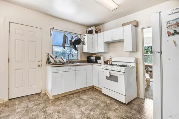 a bedroom with a bed chair and a window