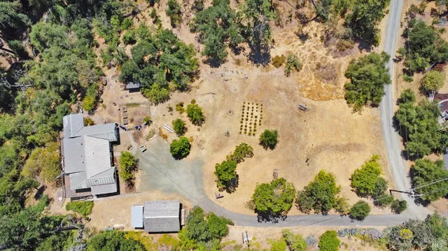 a patio with a table and chairs and potted plants