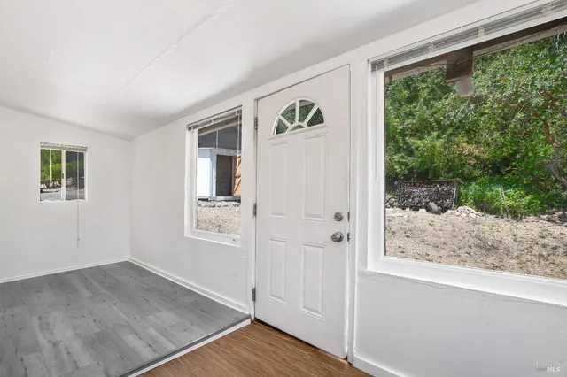a kitchen with a stove a refrigerator and a wooden floor