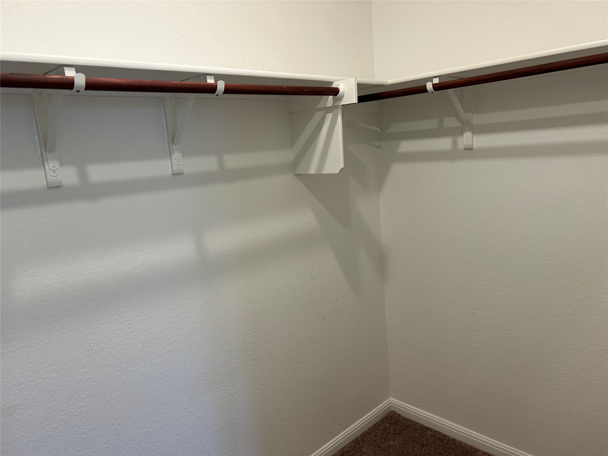 118 Two Bits Lane Elgin, TX 78621 - Photo 18 of 23 Ample hanging rods and shelving maximize storage space within this walk-in closet.