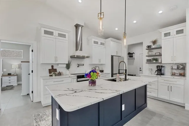 a kitchen with stainless steel appliances a refrigerator and a stove