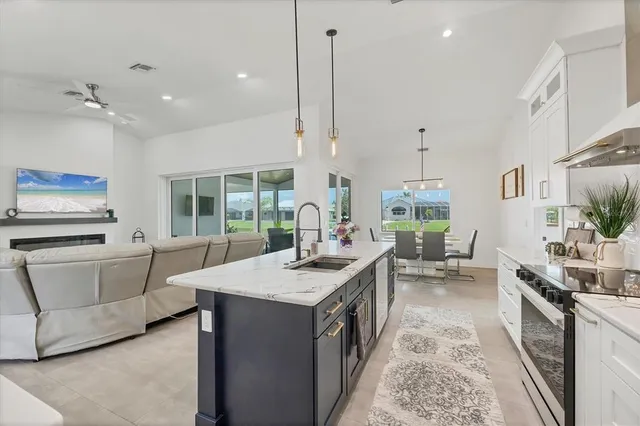 a dining room with furniture a chandelier and wooden floor