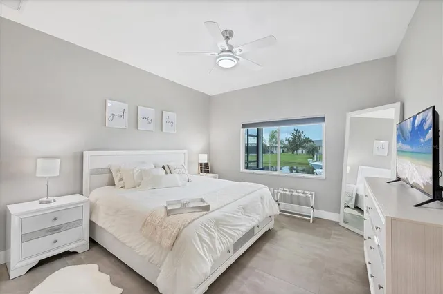 a dining room with furniture water view and a floor to ceiling window