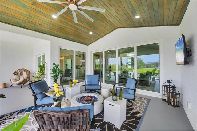 an aerial view of a house with a garden and lake view