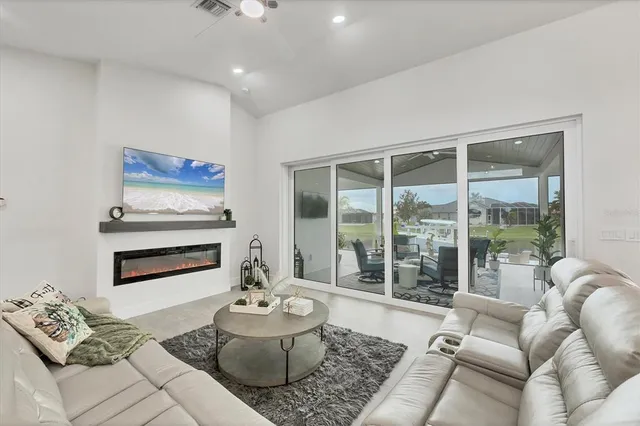 a living room with furniture and a view of kitchen