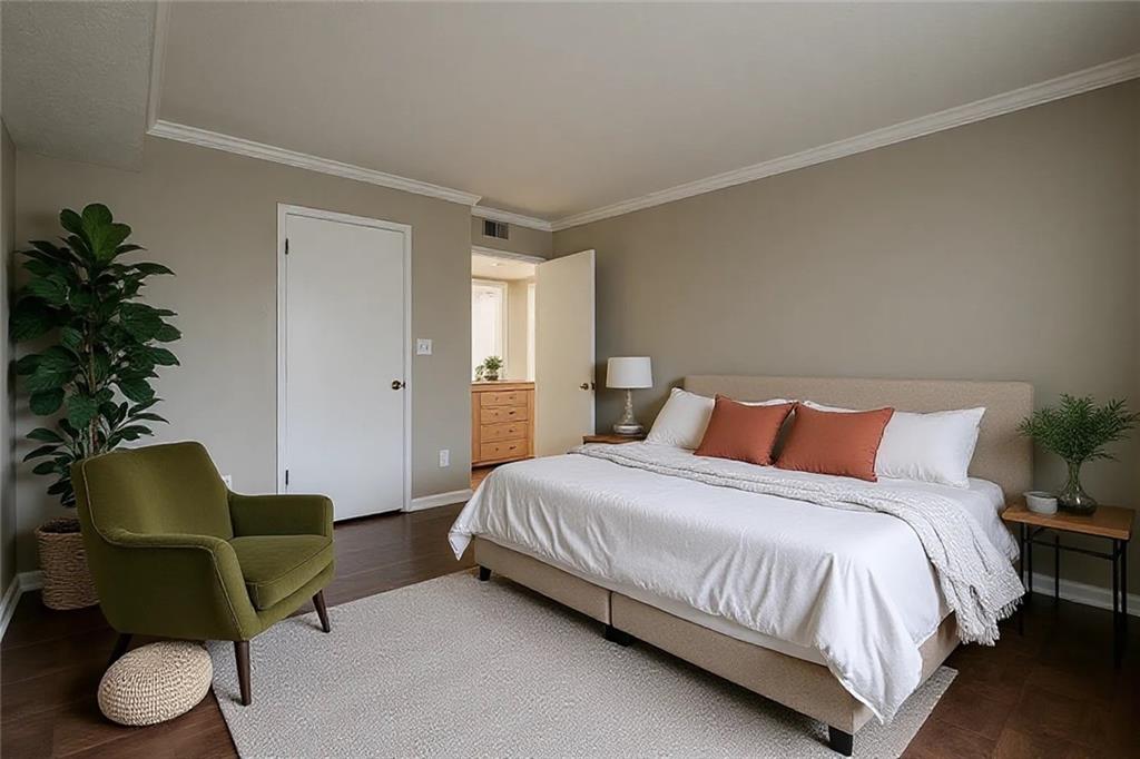 1106 Natchez Trace Atlanta, GA 30350 - Photo 12 of 40 a bedroom with a bed and a chair with the potted plants