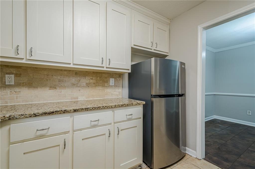 1106 Natchez Trace Atlanta, GA 30350 - Photo 15 of 40 a kitchen with granite countertop cabinets and refrigerator