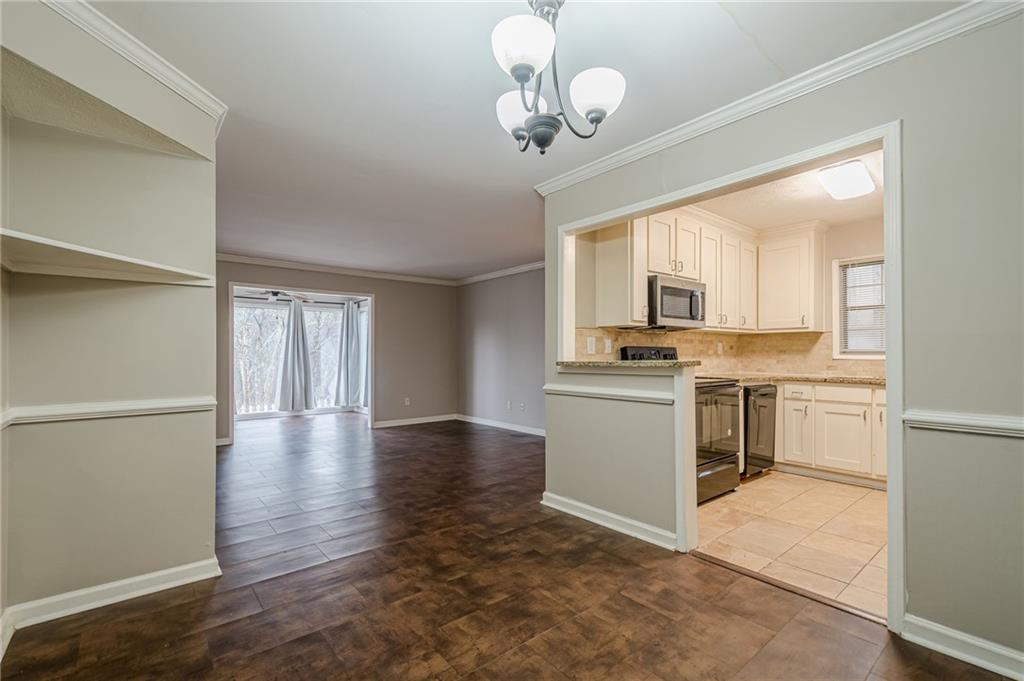 1106 Natchez Trace Atlanta, GA 30350 - Photo 17 of 40 a kitchen with a refrigerator and white cabinets