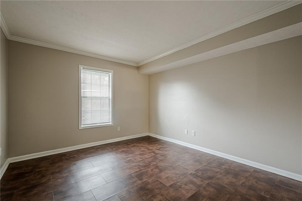 1106 Natchez Trace Atlanta, GA 30350 - Photo 23 of 40 an empty room with wooden floor and windows
