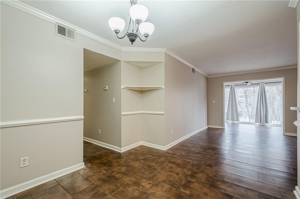 1106 Natchez Trace Atlanta, GA 30350 - Photo 27 of 40 an empty room with wooden floor cabinet and windows