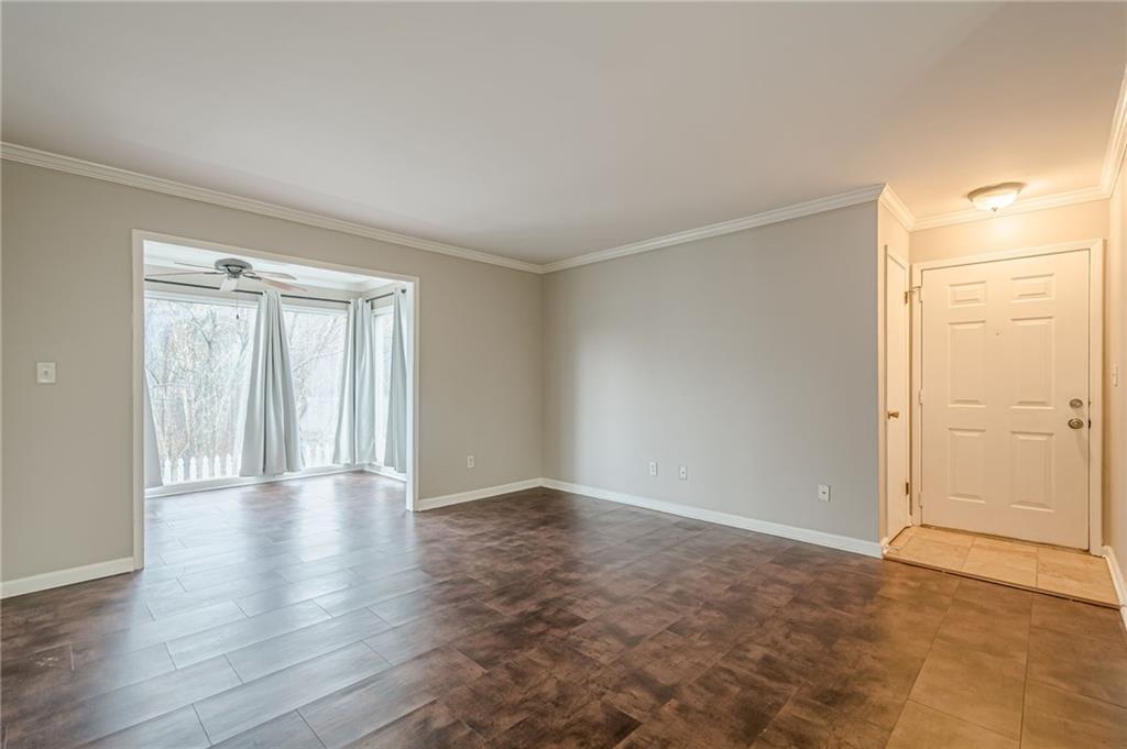 1106 Natchez Trace Atlanta, GA 30350 - Photo 32 of 40 a view of an empty room with wooden floor and a window
