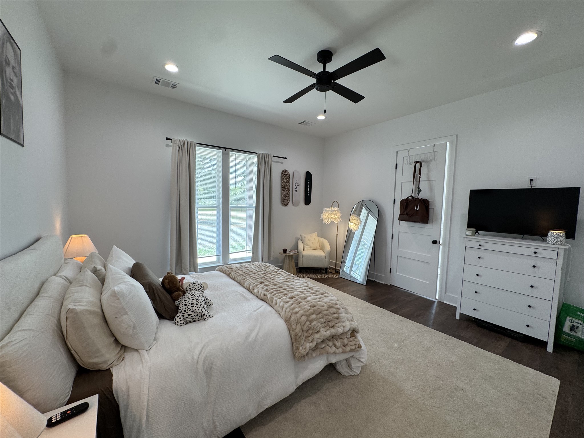 1353 Red Town Road, Unit B Elgin, TX 78621 - Photo 9 of 26 Recessed lighting and wide windows enhance the clean architectural lines of this modern bedroom.