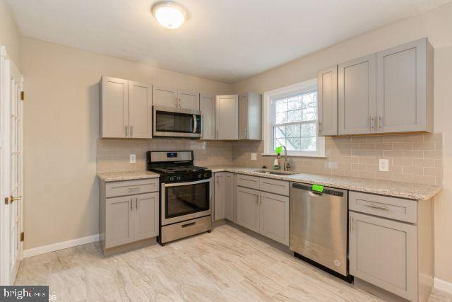 126 4th Avenue Mount Ephraim, NJ 08059 - Photo 10 of 26 a kitchen with granite countertop white cabinets and appliances