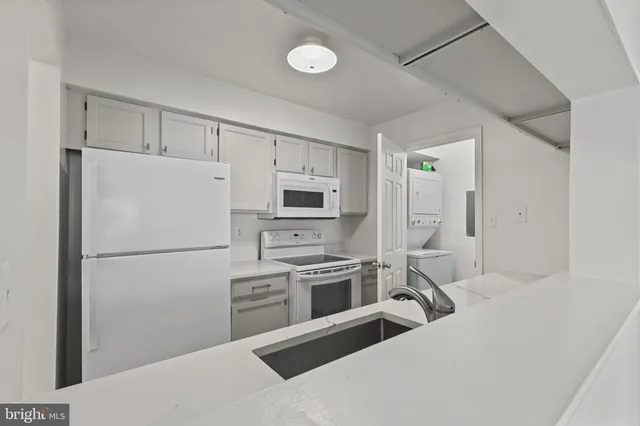 a kitchen with stainless steel appliances a refrigerator sink and stove