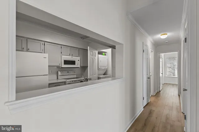 a kitchen with stainless steel appliances a refrigerator and microwave