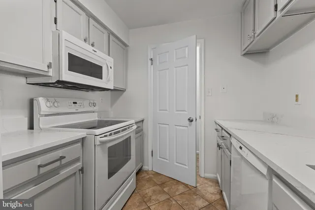 a kitchen with a sink stove and microwave
