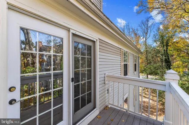 a view of a balcony with wooden fence and floor