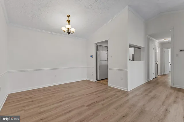 a view of a livingroom with wooden floor and a ceiling fan