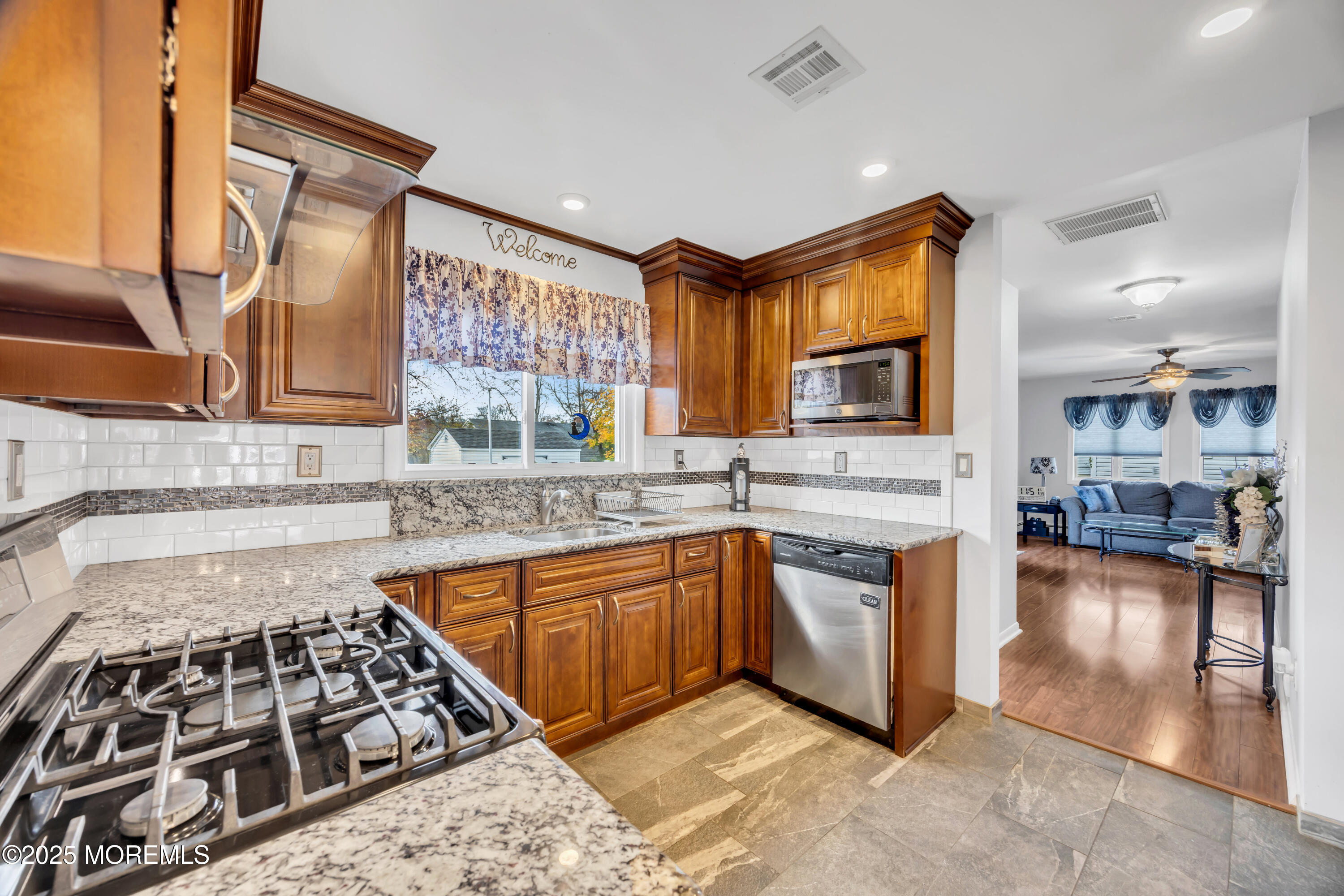 308 Green Tree Road Brick, NJ 08724 - Photo 15 of 58 a kitchen with stainless steel appliances granite countertop a stove a sink and a microwave