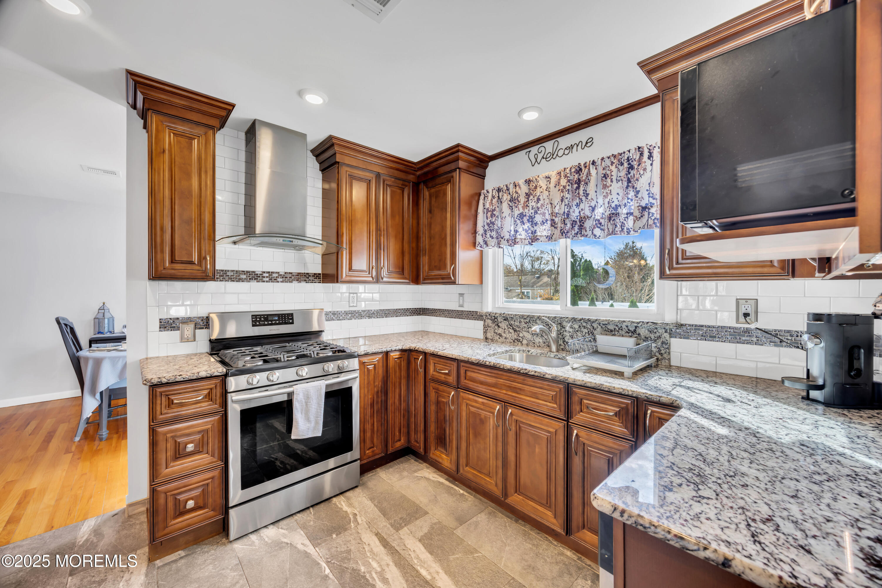 308 Green Tree Road Brick, NJ 08724 - Photo 18 of 58 a kitchen with stainless steel appliances granite countertop a stove a sink and a microwave