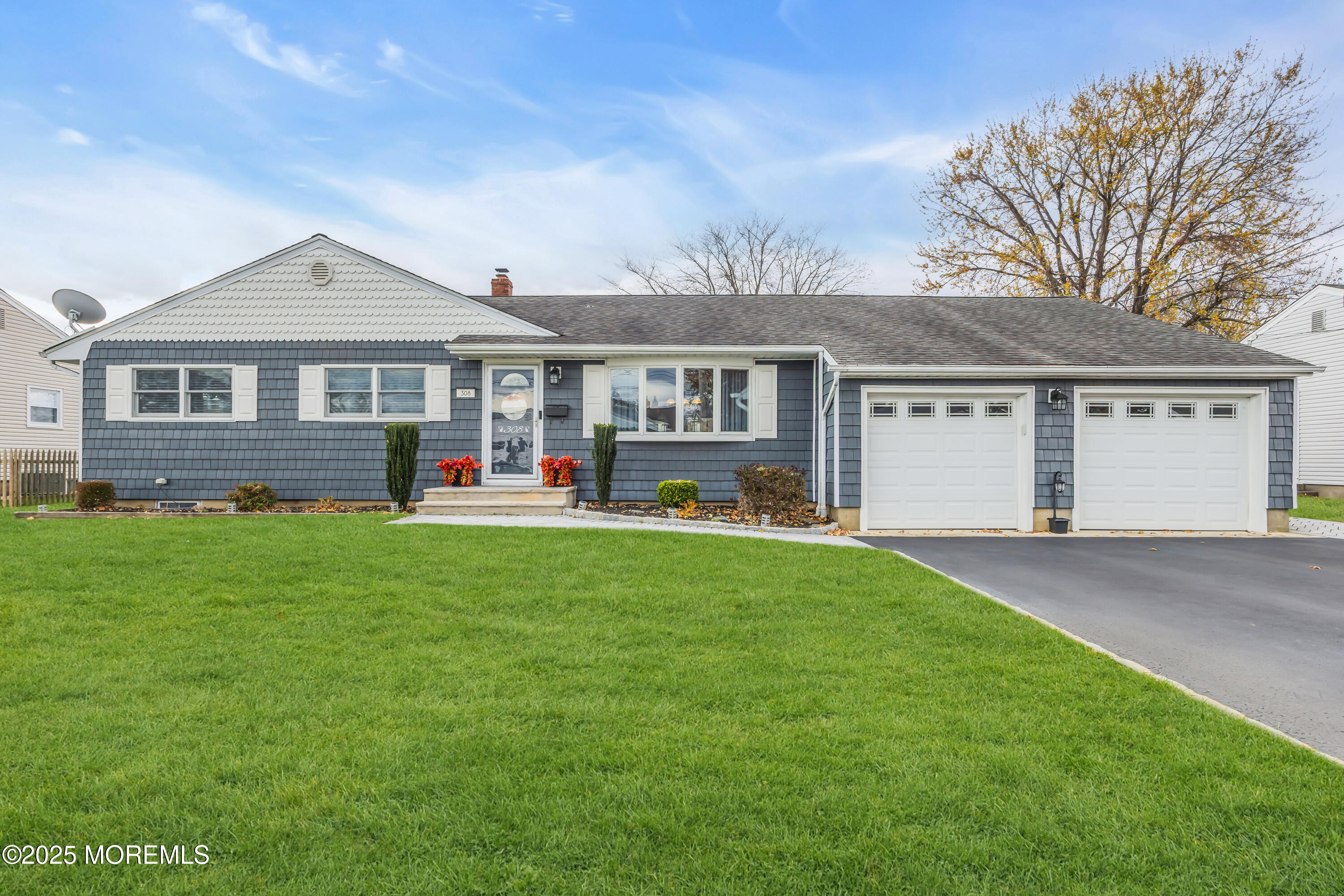 308 Green Tree Road Brick, NJ 08724 - Photo 3 of 58 a front view of a house with a garden and yard