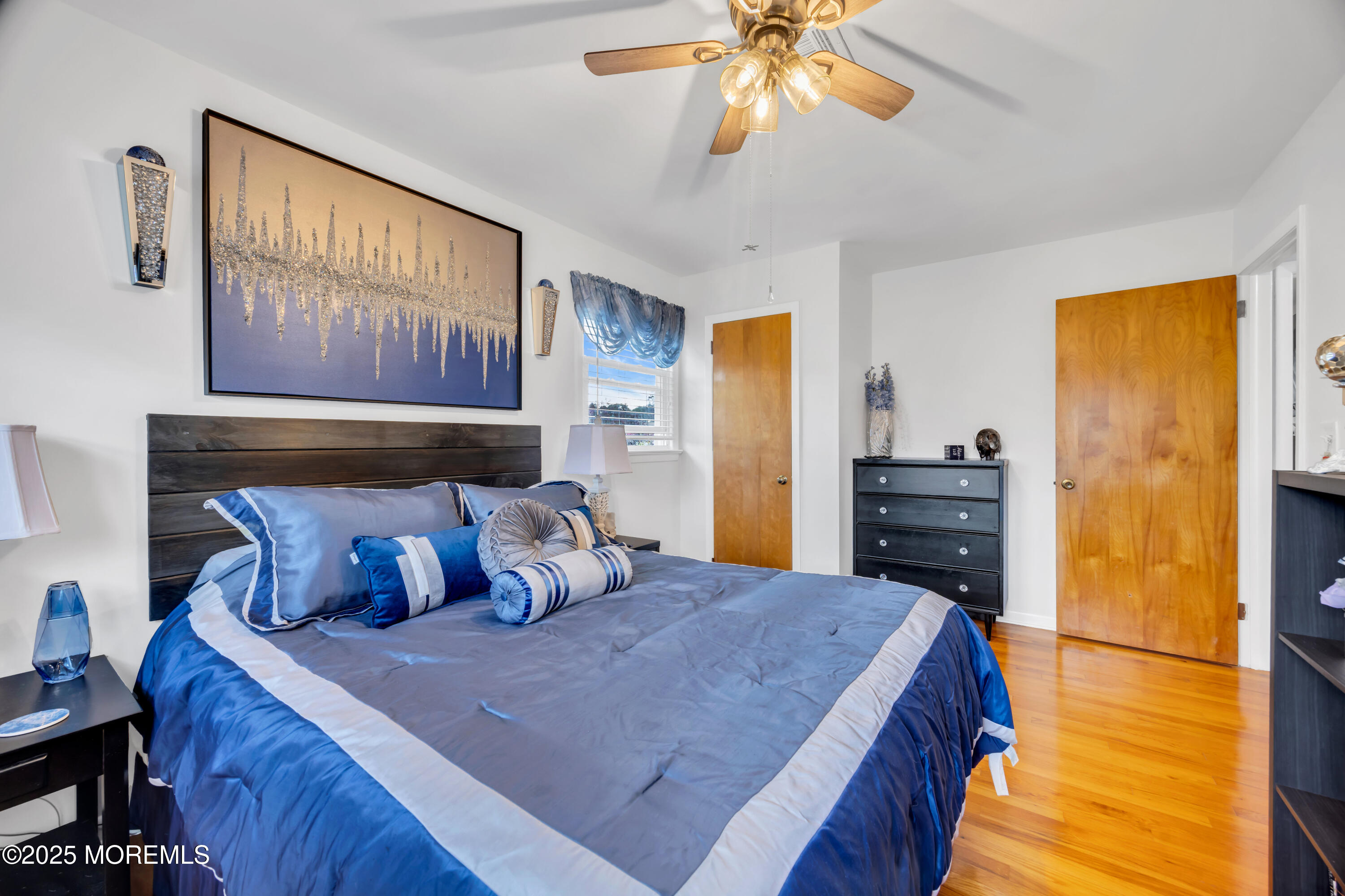 308 Green Tree Road Brick, NJ 08724 - Photo 33 of 58 a bedroom with a bed and a chandelier