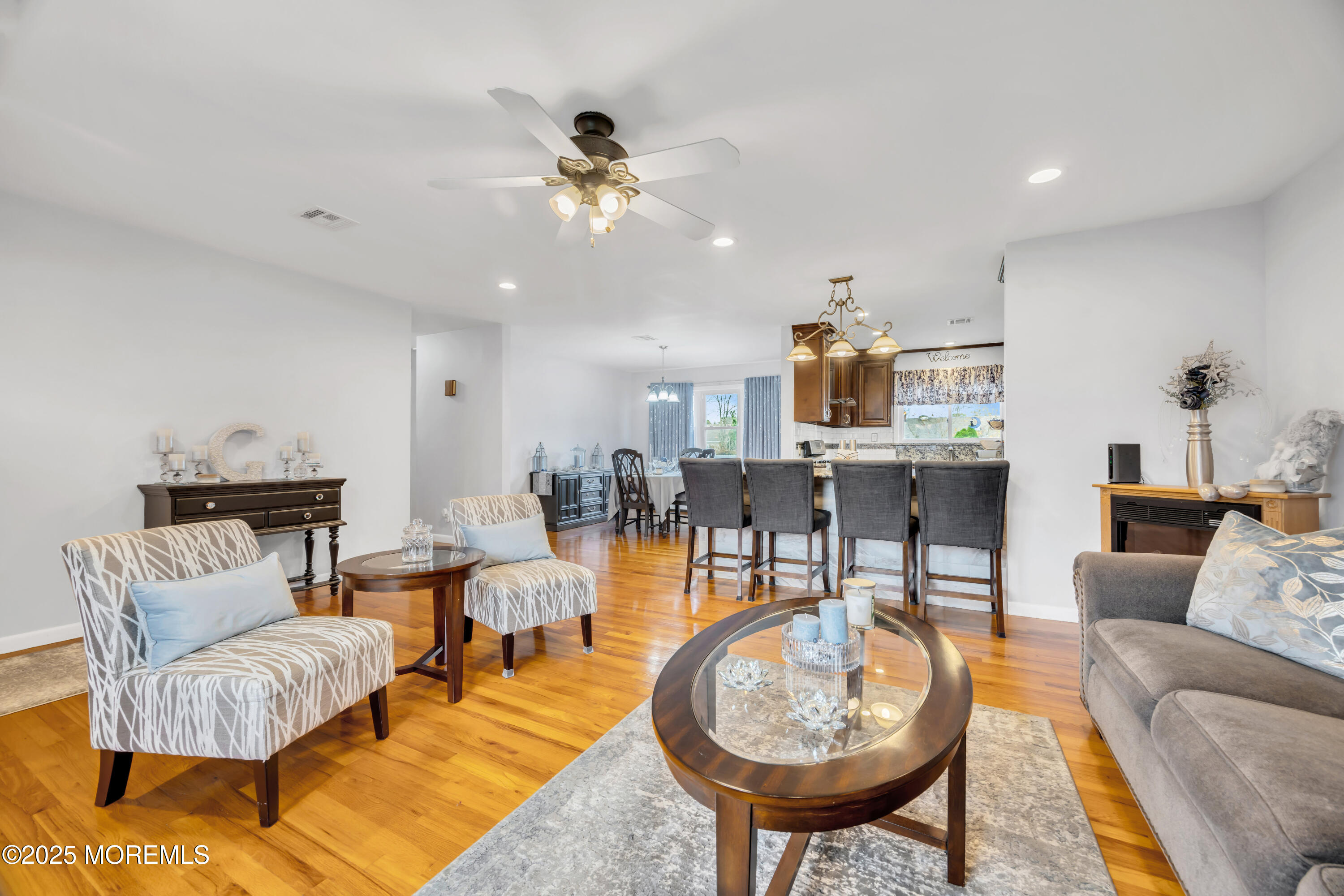 308 Green Tree Road Brick, NJ 08724 - Photo 9 of 58 a living room with furniture a rug and a chandelier