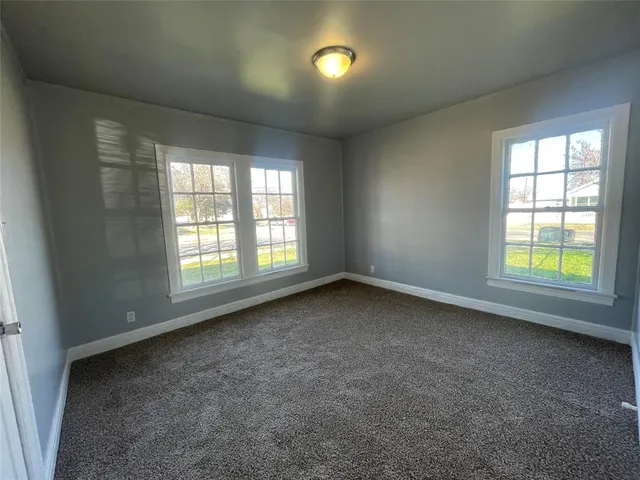 an empty room with a empty space and windows