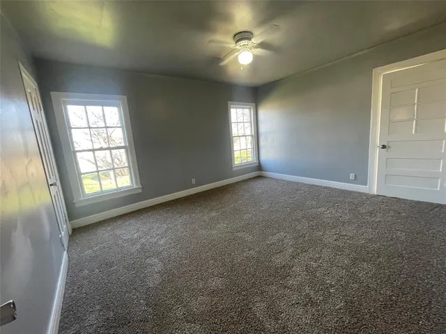 an empty room with a empty space and windows