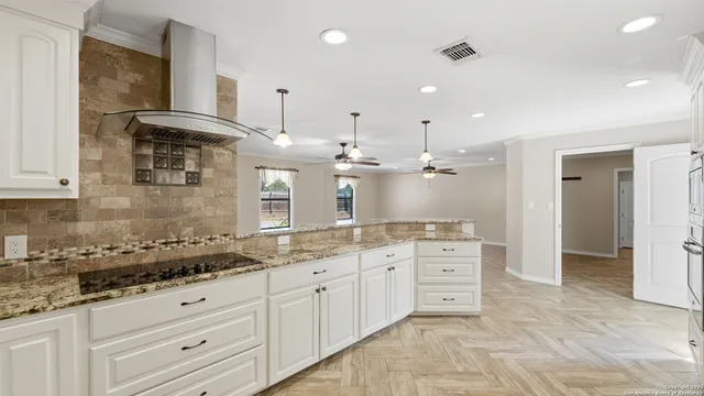 a bathroom with a granite countertop sink mirror and cabinets